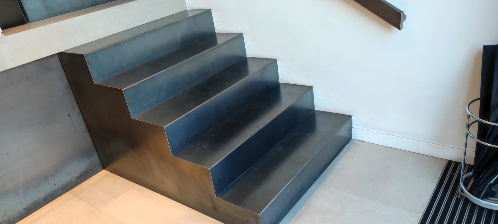 Escalera escultórica fabricada en chapa de acero plegado, instalación de interior